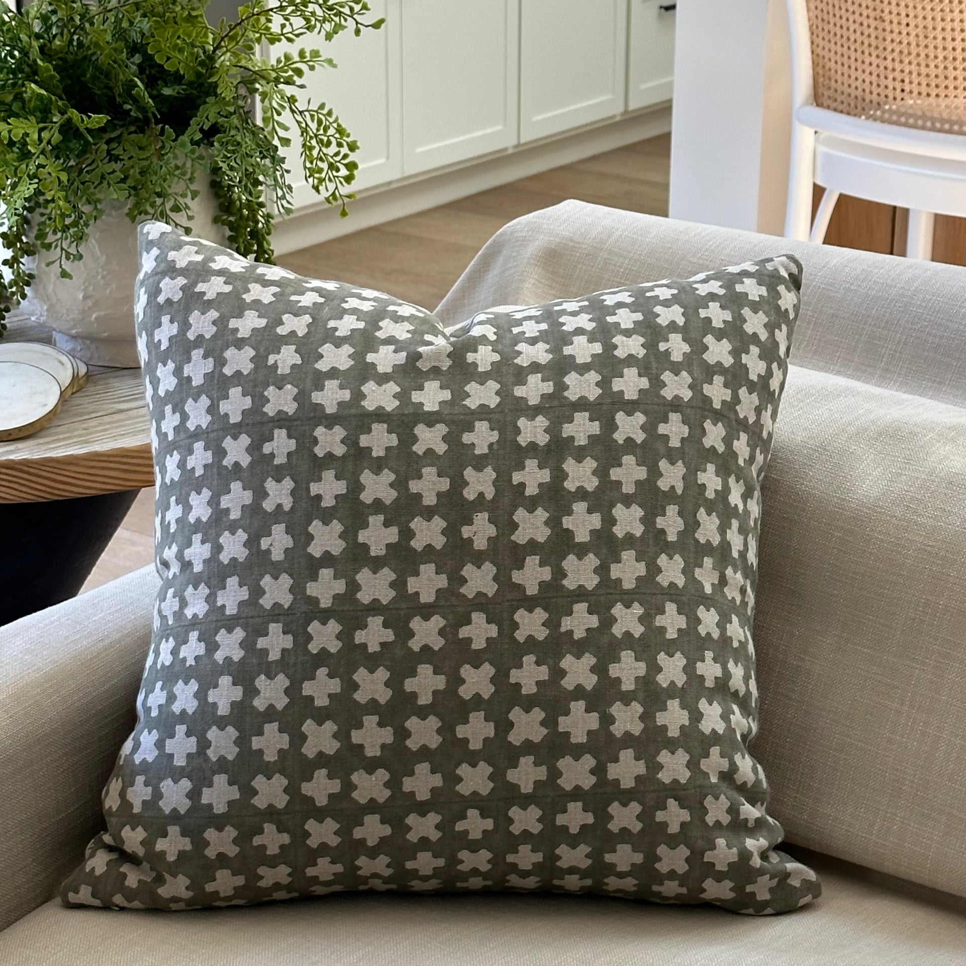 Bastideaux Bogo pillow in soft olive green with ivory geometric cross motifs