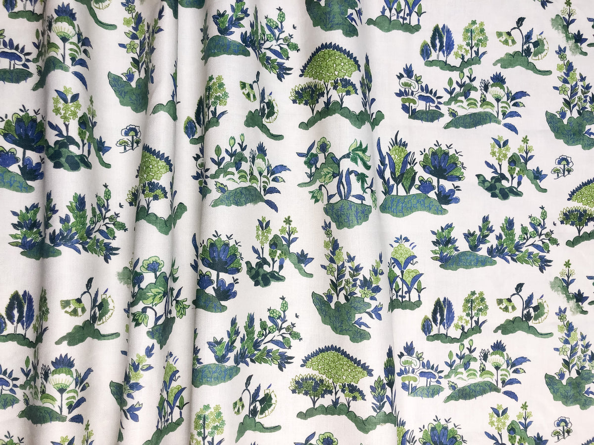 A linen fabric with a floral and fauna print, featuring various shades of blue, green, and beige. Antique Sarasa documant inspired.