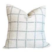 A square-shaped pillow with a marine blue and white geometric patterned fabric.