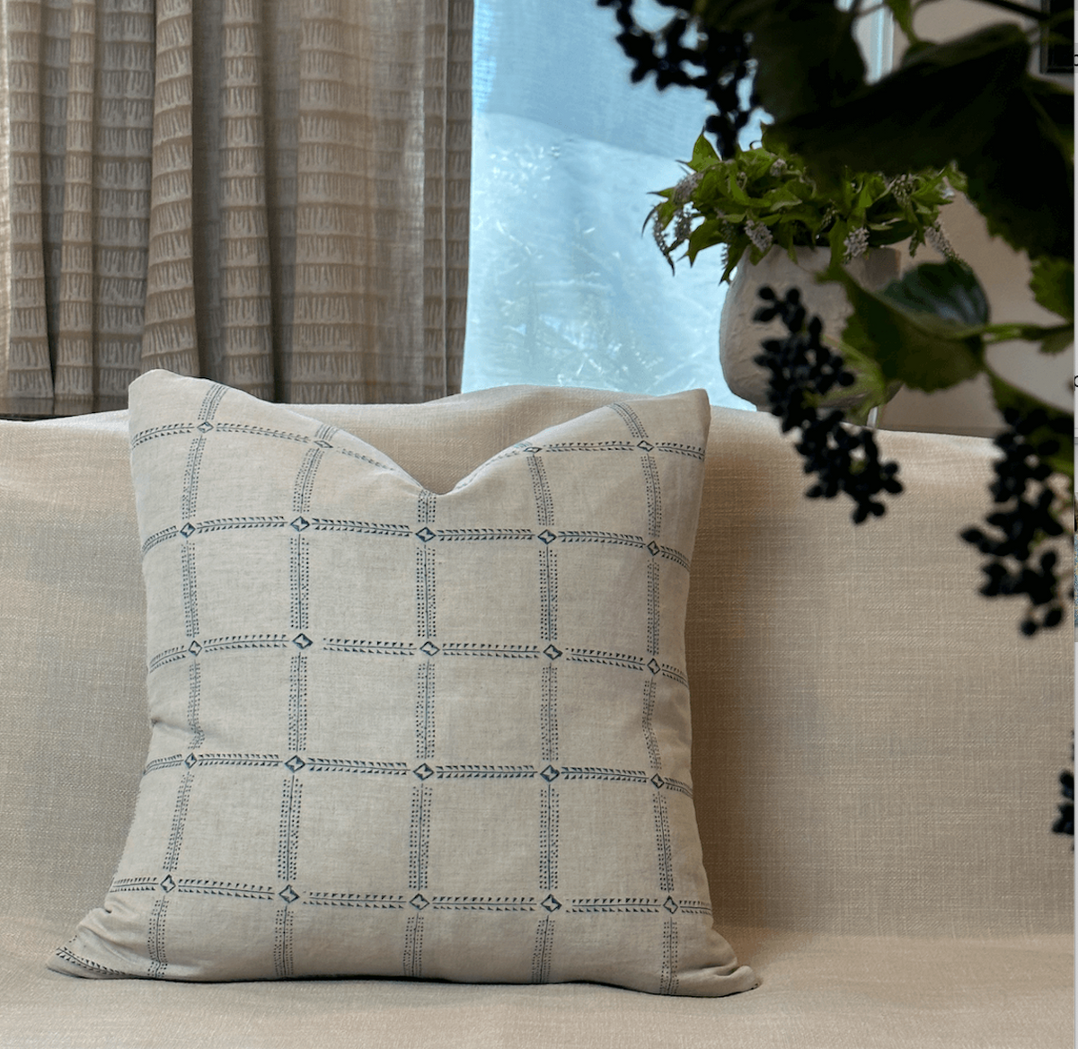 Bastideaux Ronin pillow in Marine Blue with a blue geometric grid pattern on natural linen
