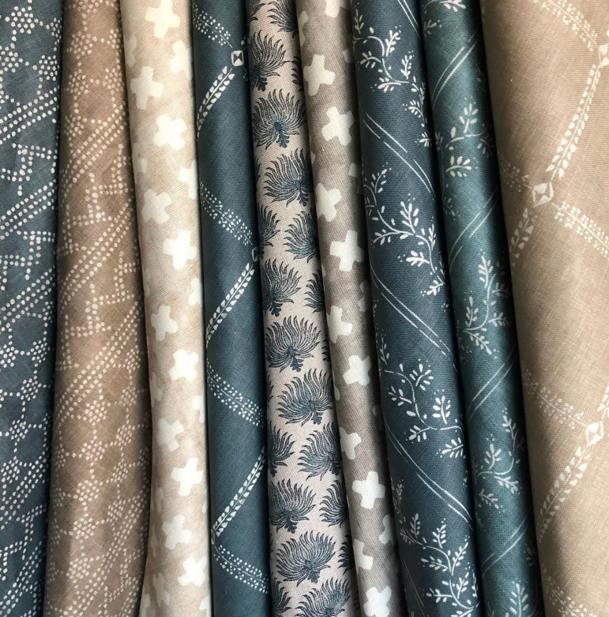 Bastideaux textiles in blue, taupe and natural tones with geometric and floral patterns