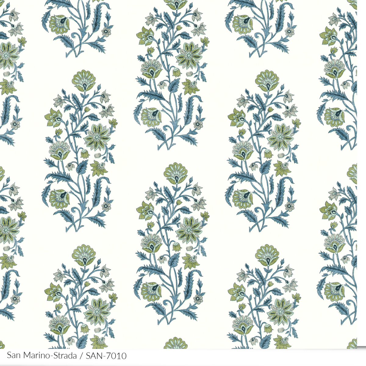 A San Marino textile print detail with a floral pattern in various colors, predominantly blue and green, with a white linen background.