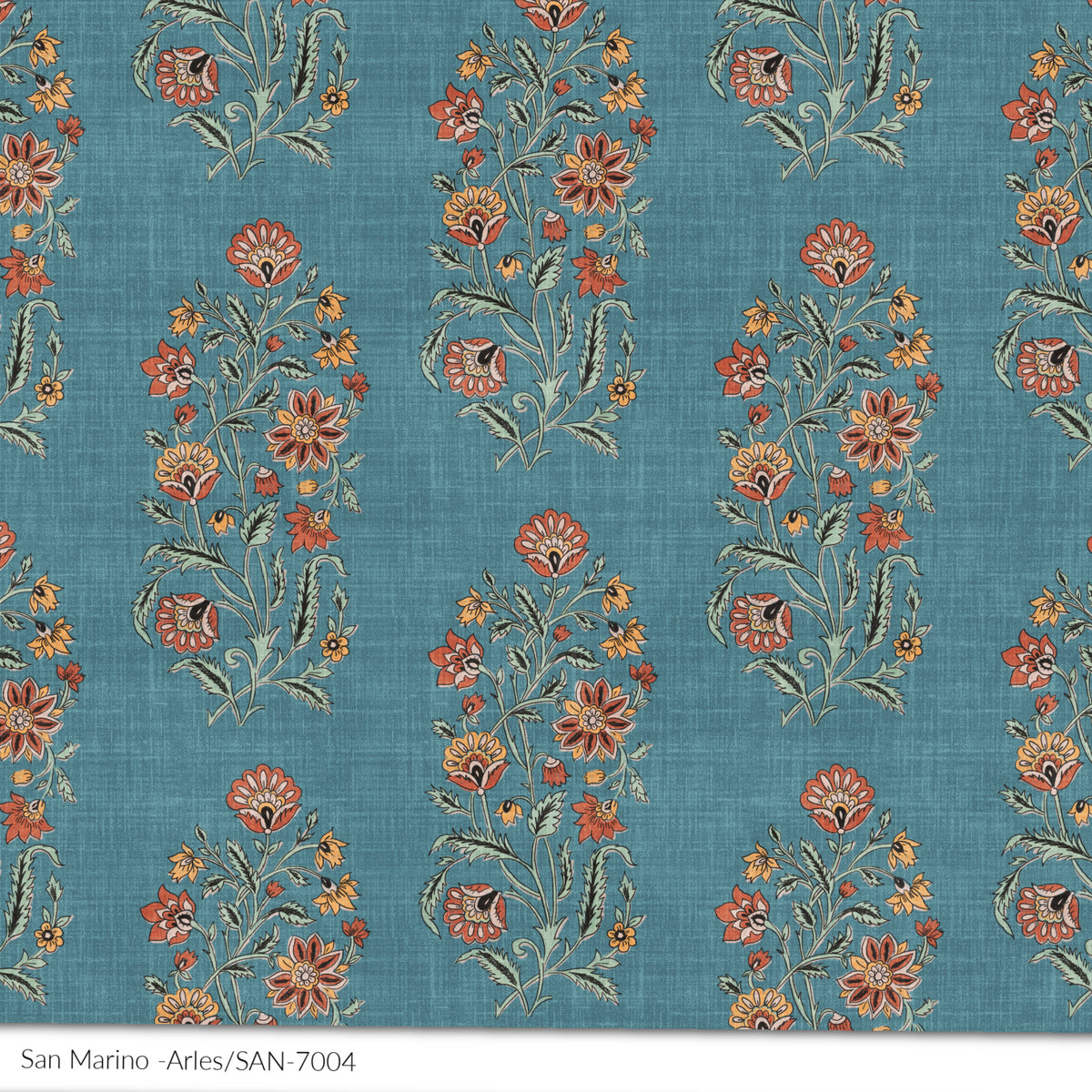 A textile print detail with a floral pattern in various colors, predominantly blue back ground with terracota, ochre green, with a textured linen texture.